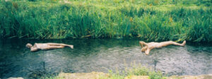 Sleeper and Dreamer over water; life sized figures in ceramic